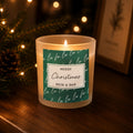 Personalised Fa La La Christmas Candle Jar glowing on a side table