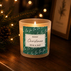 Personalised Fa La La Christmas Candle Jar glowing on a side table