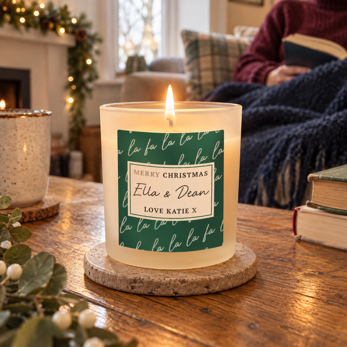 Personalised Fa La La Christmas Candle Jar lit on a coffee table