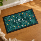 Personalised Christmas fairy lights pet bowl mat with a food bowl on a kitchen floor