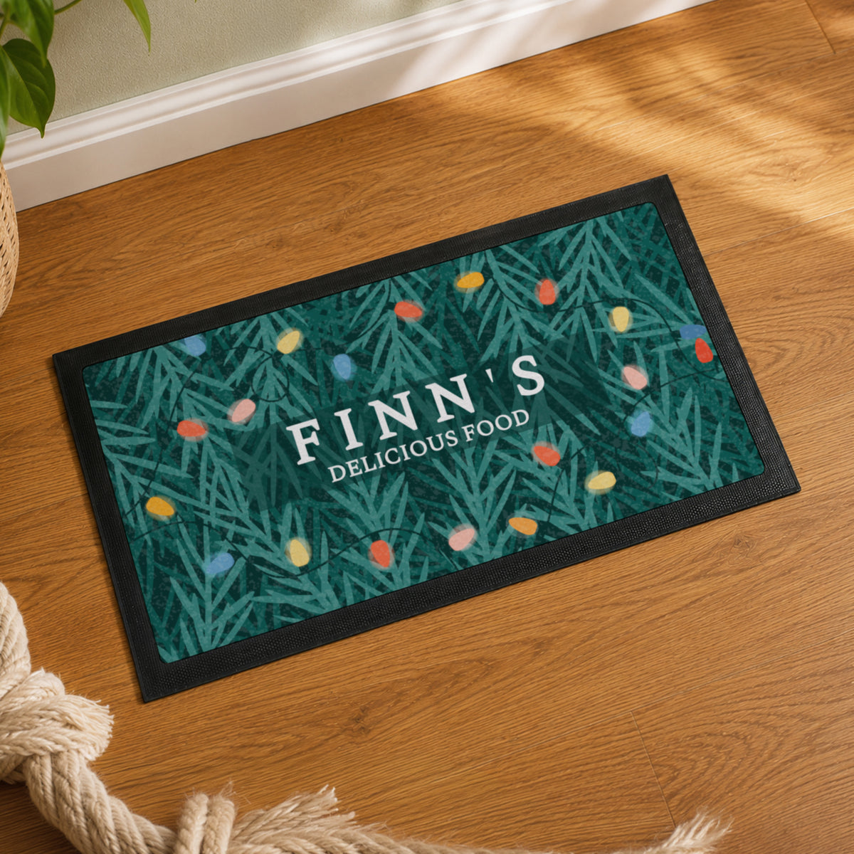 Personalised Christmas fairy lights pet bowl mat with a food bowl on a kitchen floor