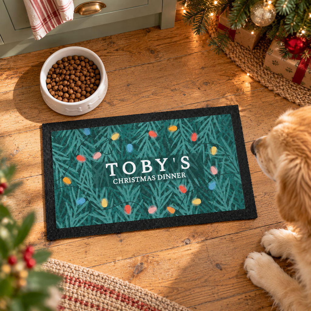 Personalised Christmas fairy lights pet bowl mat on a kitchen floor with a food bowl and dog