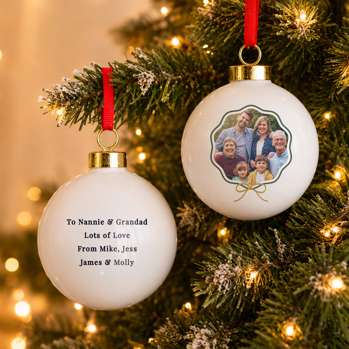 Personalised Scallop Bow Photo Ceramic Bauble hanging on a Christmas tree