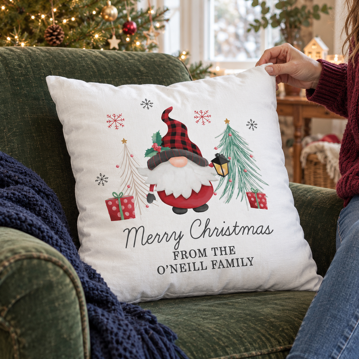Personalised Gonk Merry Christmas Cushion on a green velvet armchair