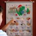 Personalised Dinosaur Advent Calendar hanging on the wall at Christmas