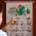 Personalised Dinosaur Advent Calendar hanging on the wall at Christmas