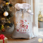 Personalised Unicorn Christmas Sack beside the Christmas tree