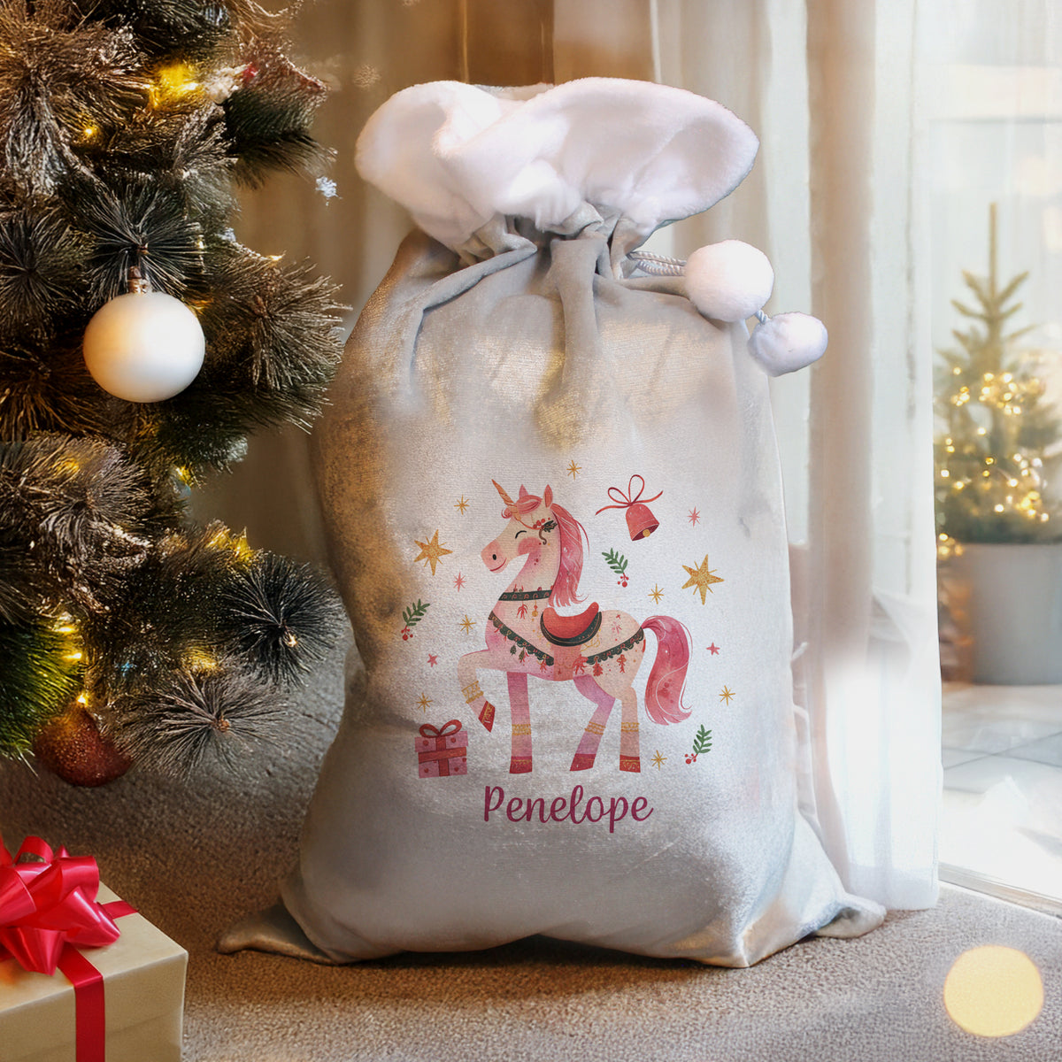 Personalised Unicorn Christmas Sack beside the Christmas tree