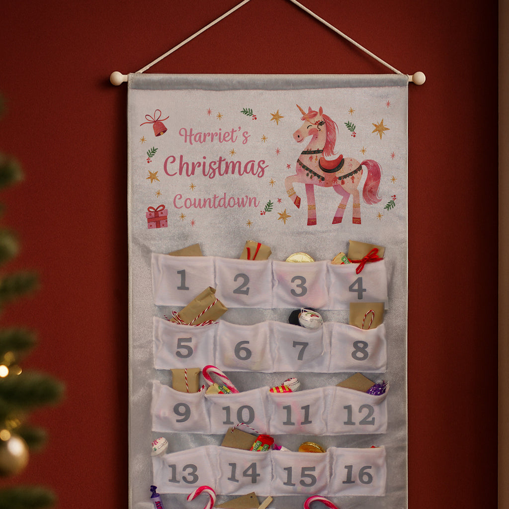 Personalised Unicorn Christmas Advent Calendar hanging on the wall at Christmas