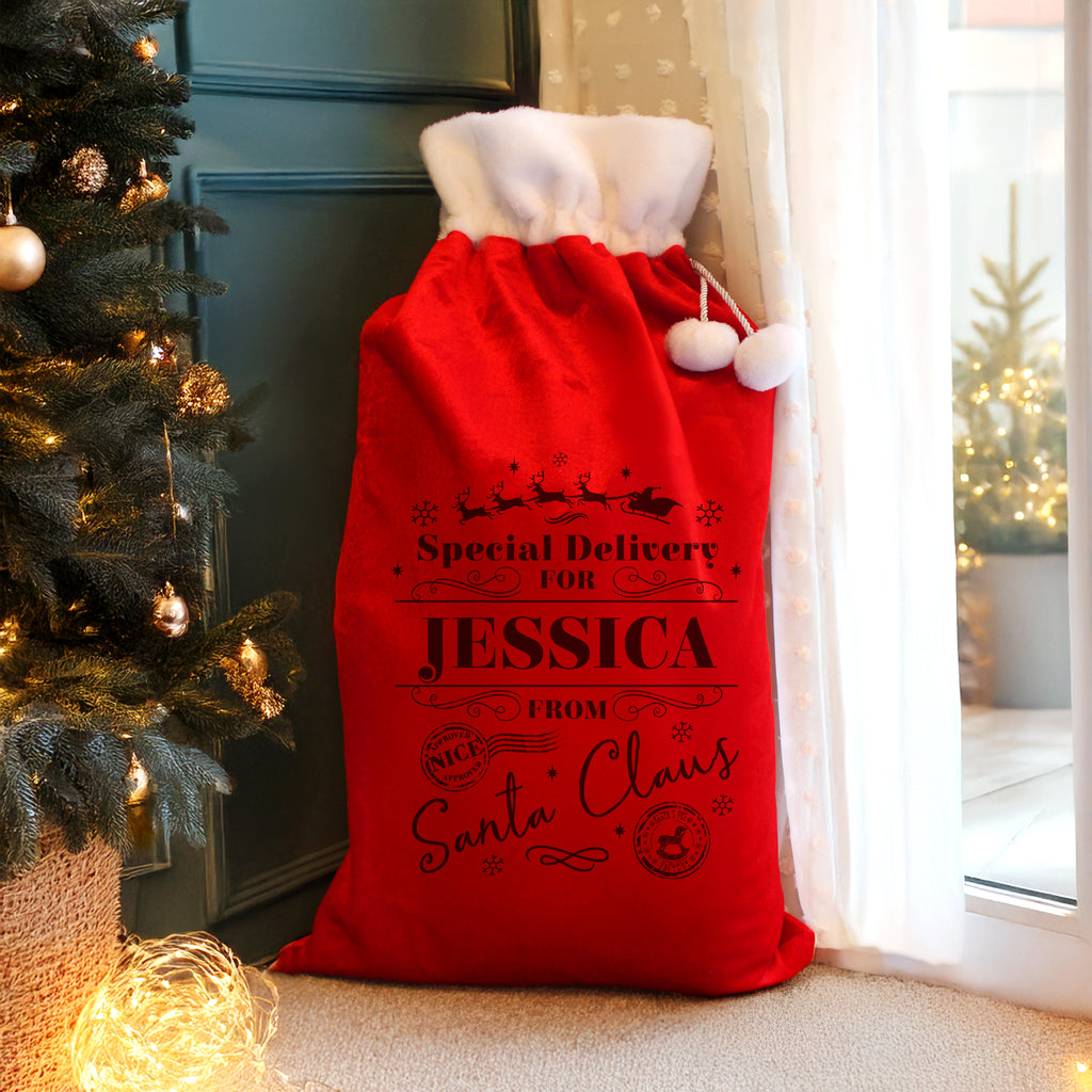 Personalised Special Delivery Red Christmas Sack beside the Christmas tree