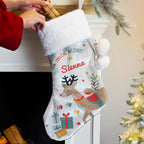 Personalised Reindeer Special Delivery Christmas Stocking hanging by the fireplace