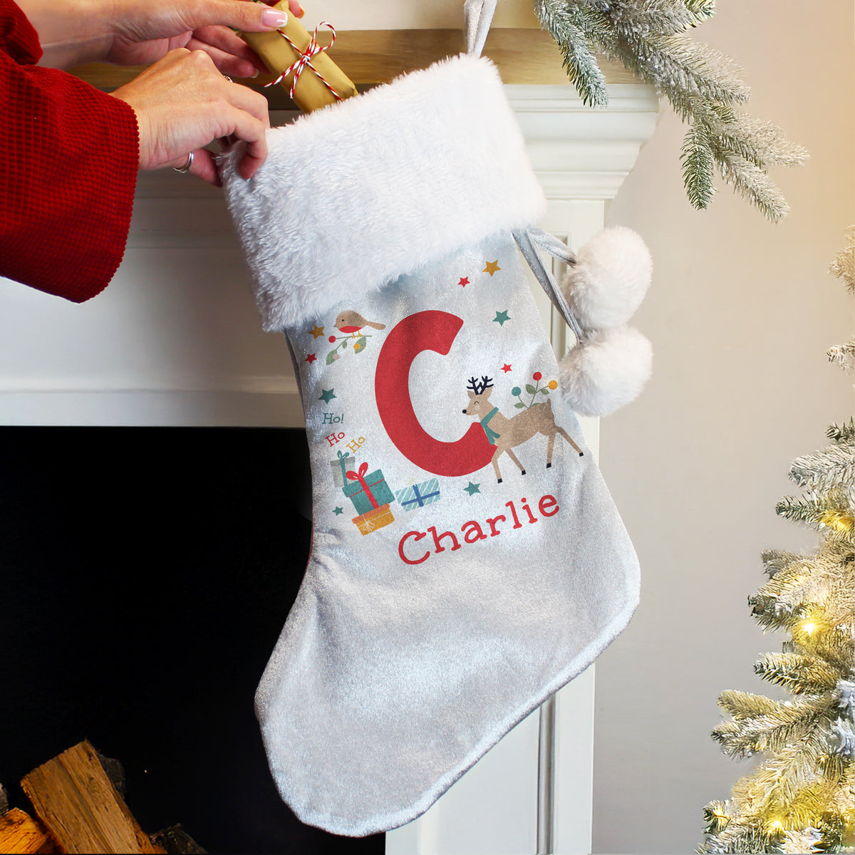 Personalised Initial Reindeer Christmas Stocking hanging by the fireplace
