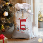 Personalised Initial Reindeer Christmas Sack beside the Christmas tree