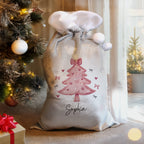 Personalised Pink Bow Christmas Tree Sack beside the Christmas tree