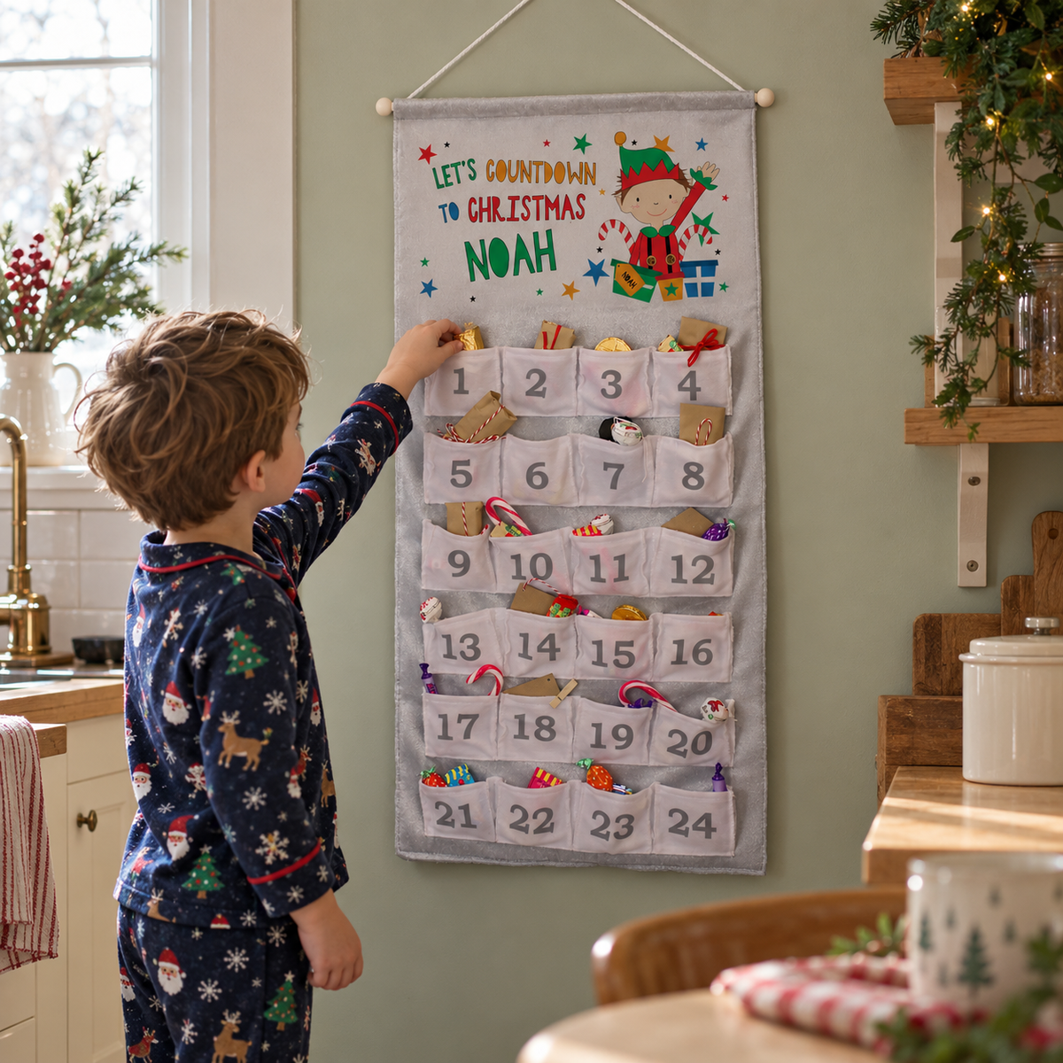 Child reaching into the Personalised Christmas Elf Advent Calendar hanging in a kitchen