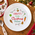 Personalised First Christmas Dinner plate on a festive table with a baby spoon