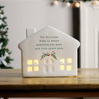 Personalised Christmas Ceramic LED House glowing on a shelf