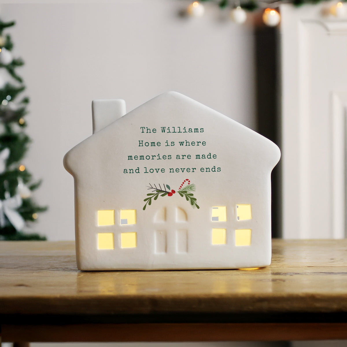 Personalised Christmas Ceramic LED House glowing on a shelf