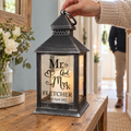 Personalised Mr & Mrs Rustic Black LED Lantern glowing on a hallway table