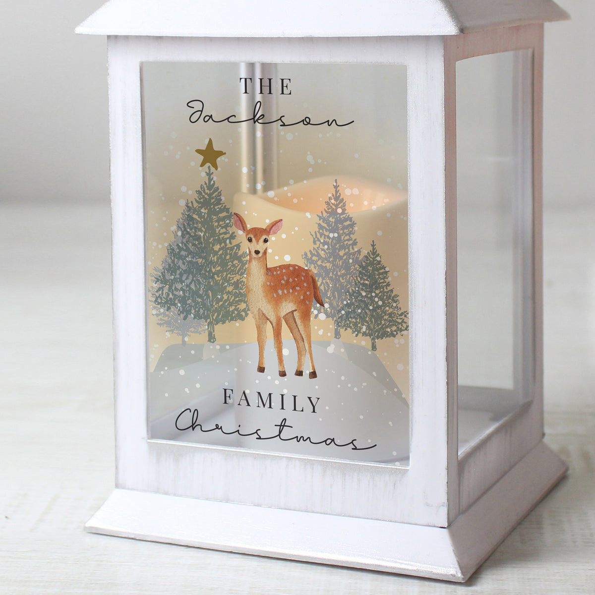 Personalised Christmas Deer White LED Lantern glowing beside a Christmas tree
