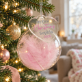 Personalised My First Christmas pink feather glass bauble hanging on the tree