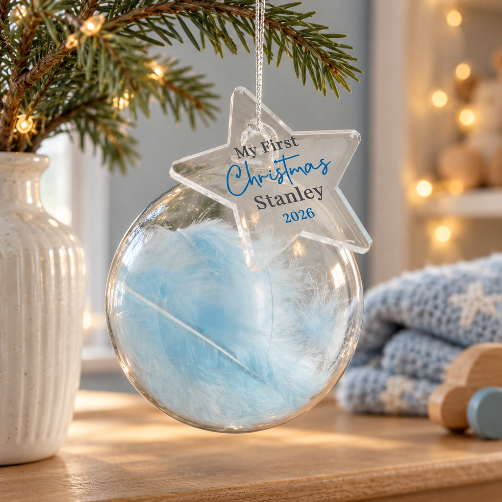 Personalised My First Christmas blue feather glass bauble hanging in a nursery