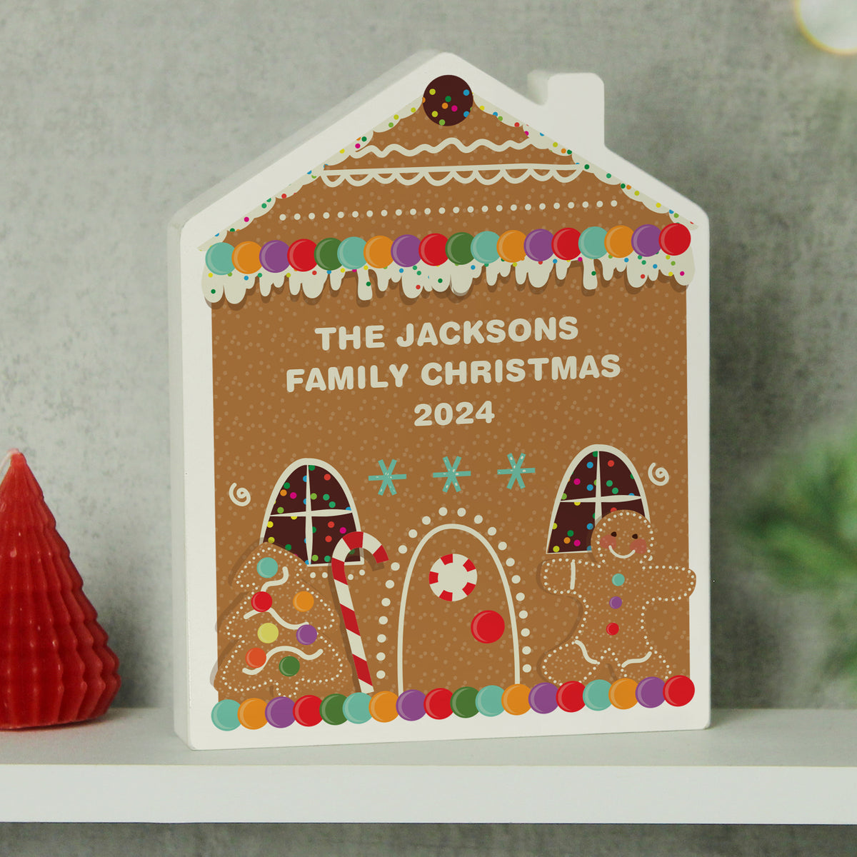 Personalised Gingerbread House Wooden Christmas Ornament standing on a shelf