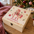 Personalised pink unicorn wooden Christmas Eve box on a table by the Christmas tree