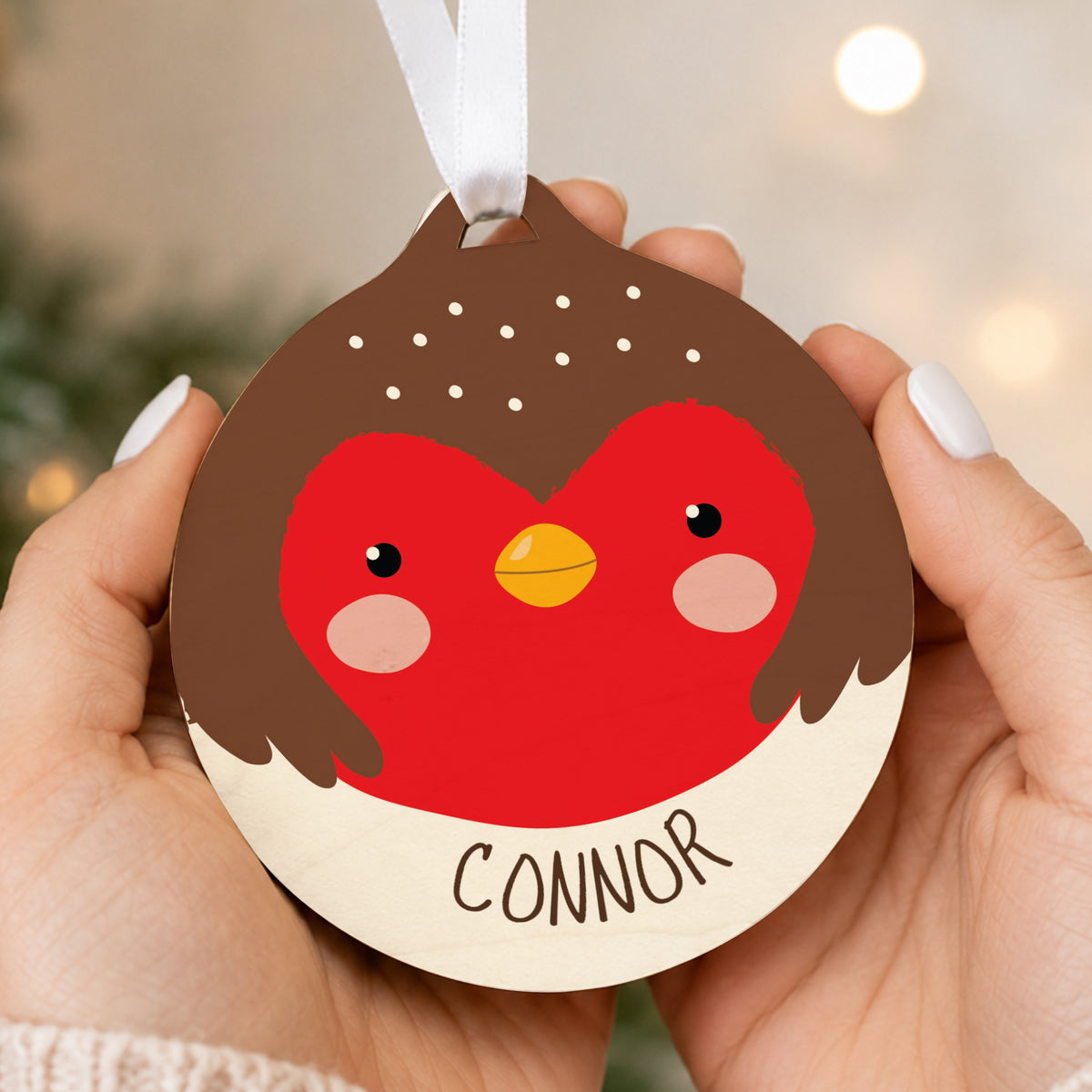 Personalised Robin Wooden Bauble hanging on a Christmas tree