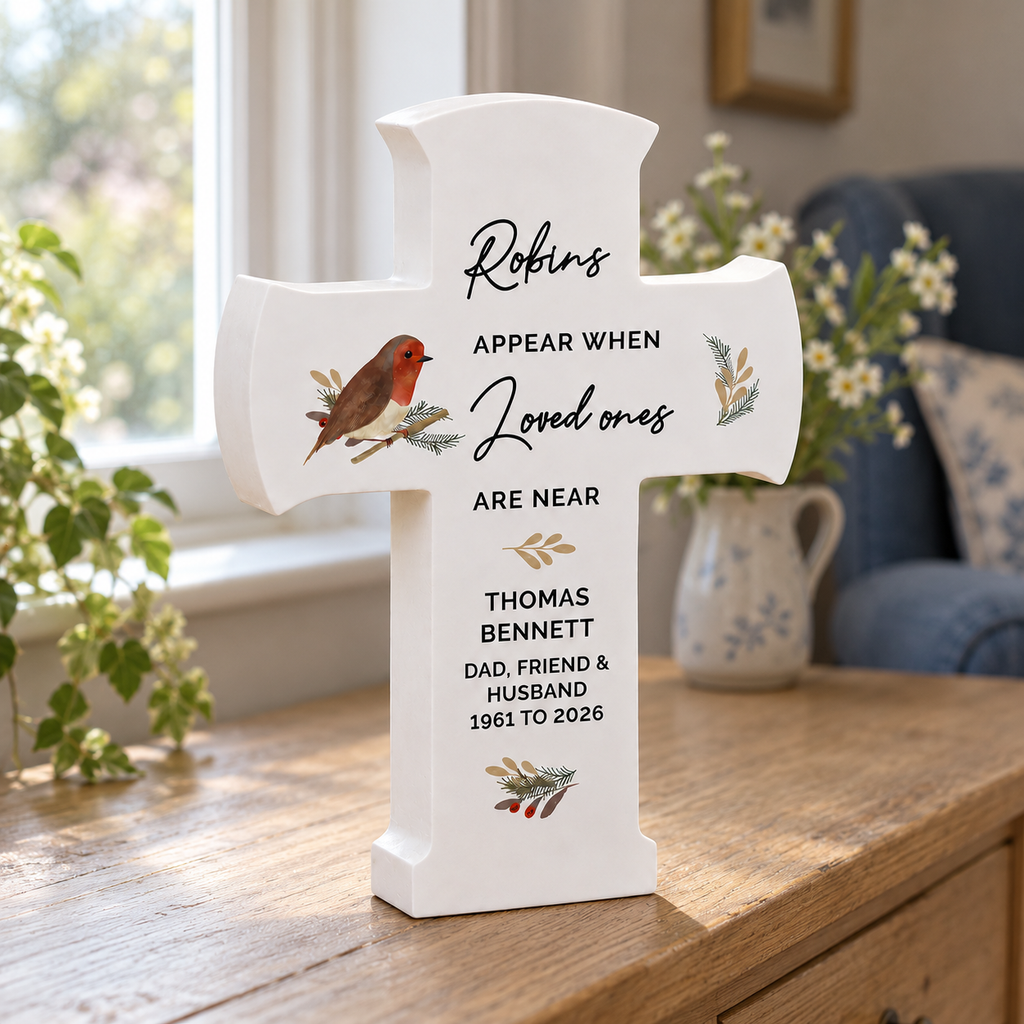 Personalised robin memorial wooden cross standing on a sideboard