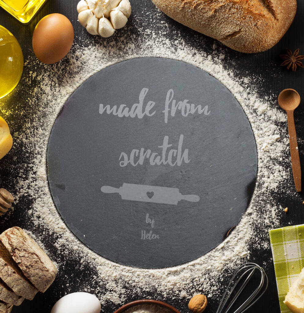 Personalised black slate cake plate displayed with a rolling pin, flour and colourful baking cases.