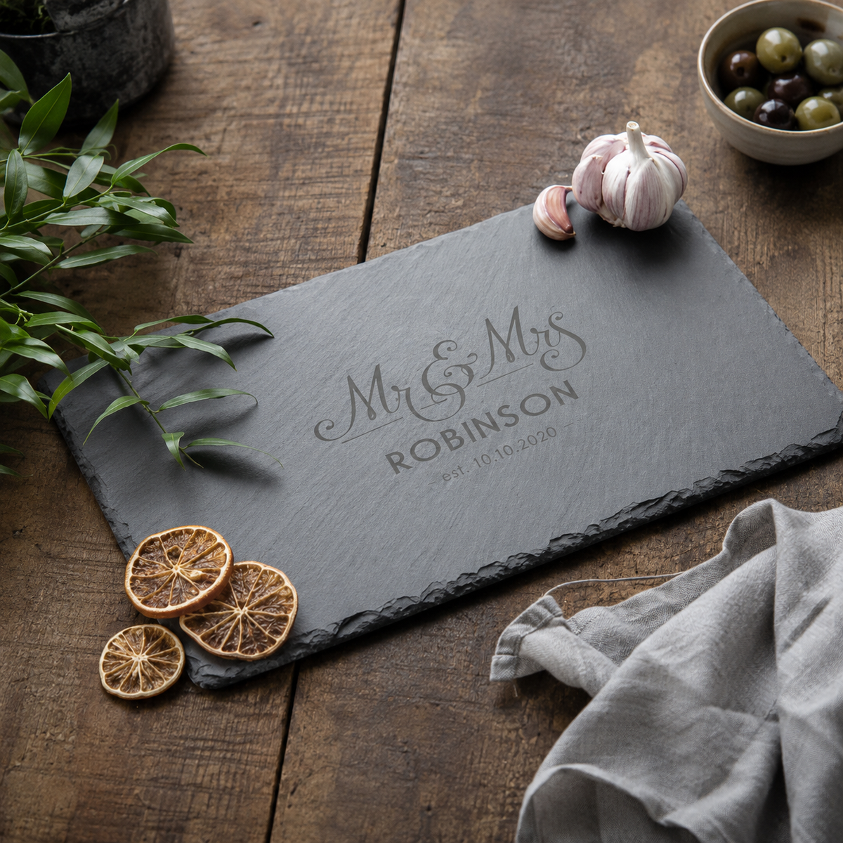 Personalised engraved slate cheeseboard featuring a Mr and Mrs design with a custom surname.