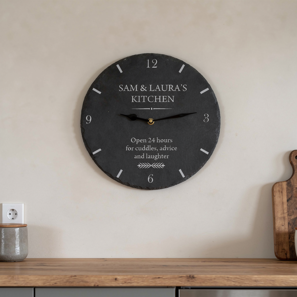 Decorative wall clock with personalized text on a kitchen wall.