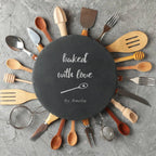 Personalised slate serving plate styled with traditional baking ingredients on a wooden worktop.