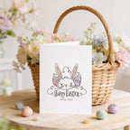 Easter card with bunny design and 'Happy Easter' text, placed in front of a floral basket.
