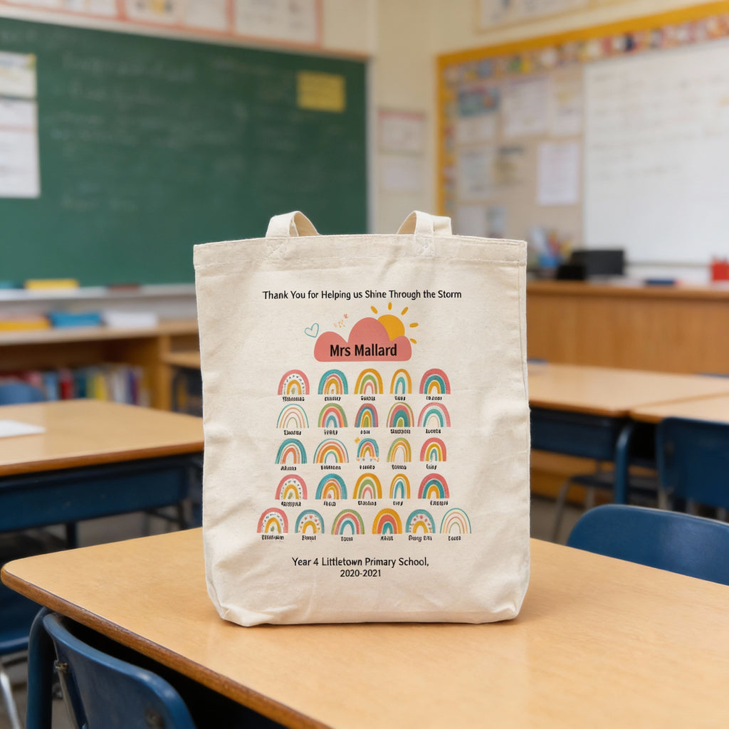 Tote bag with rainbow design and text on a classroom table