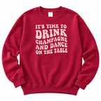 Burgundy champagne and dance slogan sweatshirt on a model against a plain white background, full product shot with sequin trousers.