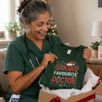 Doctor unwrapping a green Santa's Favourite Doctor Christmas sweatshirt from a gift box