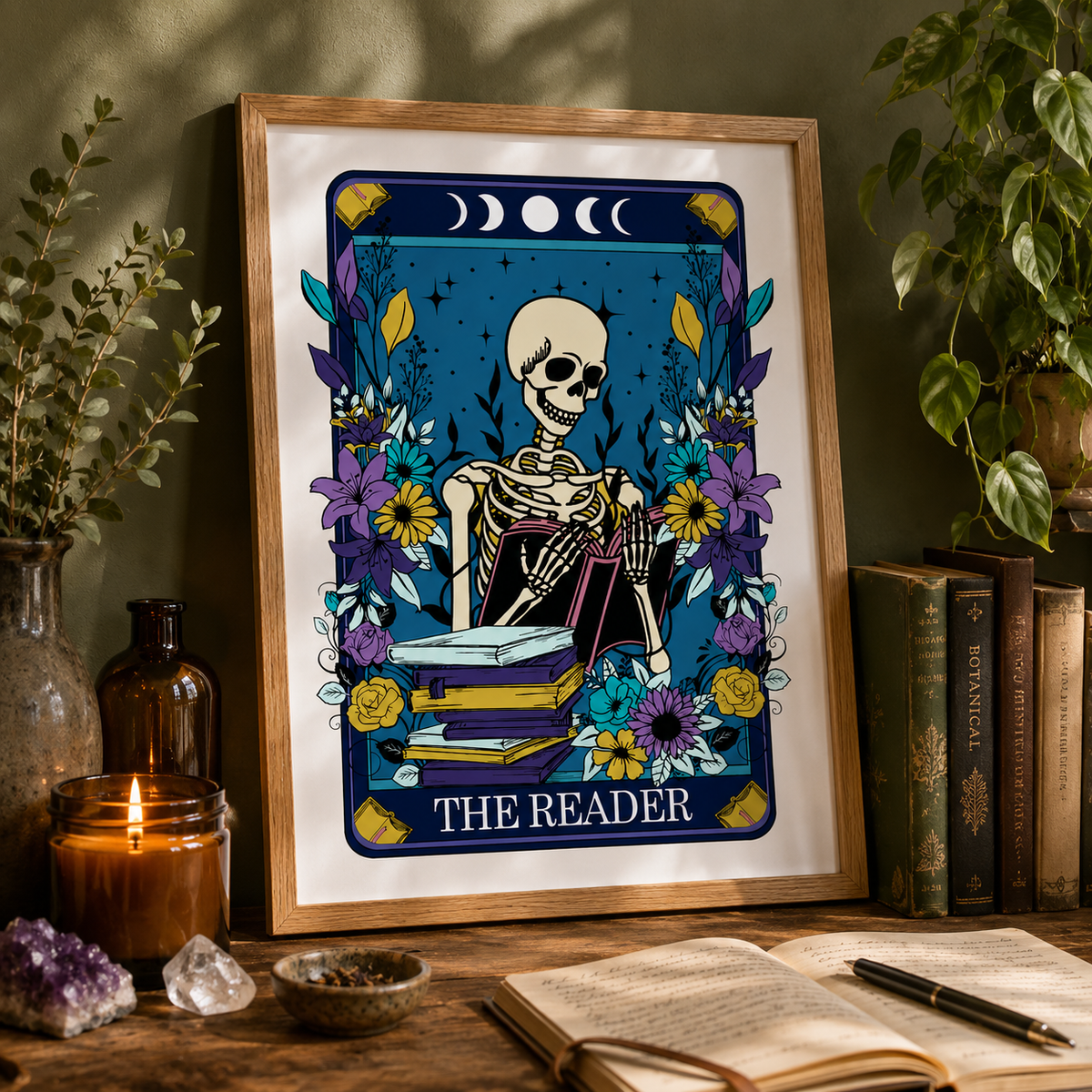 'The Reader' tarot style print with skeleton, books and flowers, framed on a wall
