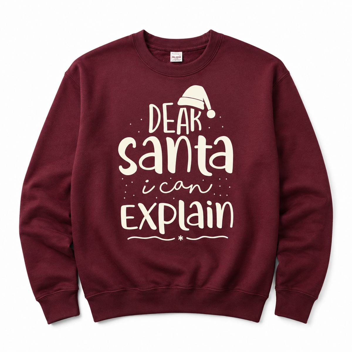 A maroon crewneck sweatshirt featuring a white graphic print that reads 'DEAR Santa i can EXPLAIN' with a small Santa hat illustration above the text, displayed on a clean white background.