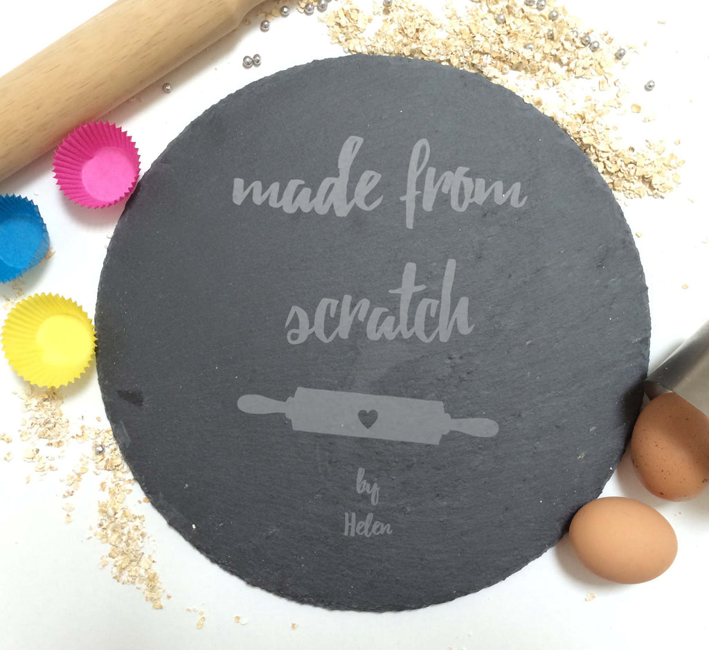 Engraved slate cake plate with “Made From Scratch” design, surrounded by traditional baking essentials.