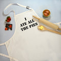 A white cooking apron with the text 'I ATE ALL THE PIES' printed in black on the front.