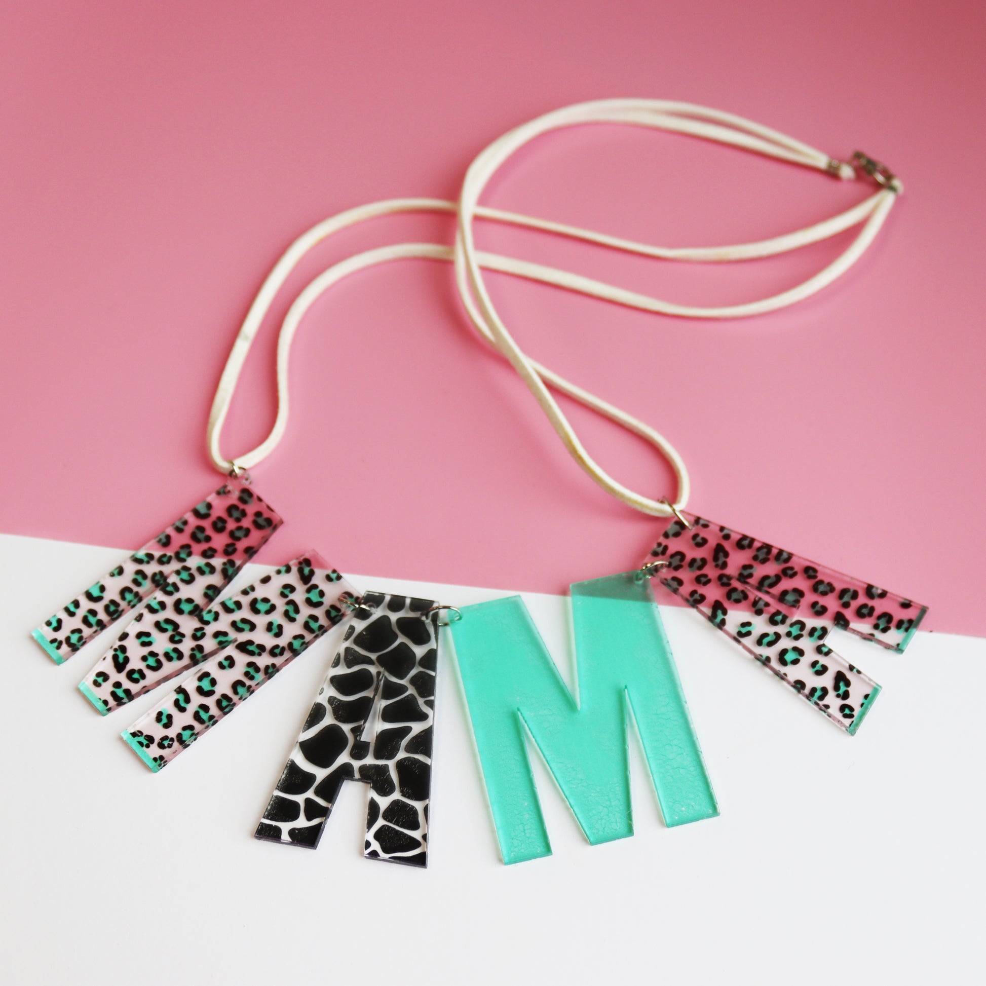 Mama leopard print acrylic necklace shown in white and pink background