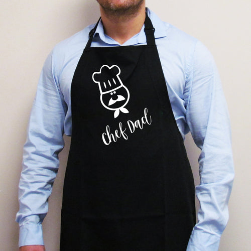 Person wearing the black 'Chef Dad' personalised apron in a kitchen