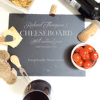 Personalised slate cheese board served with a selection of cheeses, fruit and crackers.
