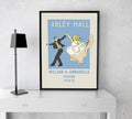 A framed vintage-style wedding print featuring a couple dancing, with a blue background, displayed on a table top easel.
