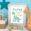 Personalised nursery print with a dinosaur, a child's name and 'Follow Your Dreams' lettering