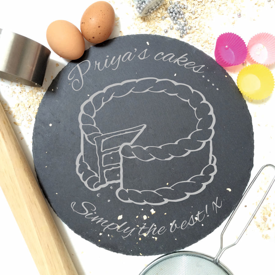 Round engraved slate board with personalised text and food-themed design in a contemporary kitchen setting.