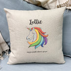 A cushion with a unicorn design and the text 'Lottie' and 'May you sparkle wherever you go' printed on it, placed on a sofa.