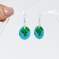 You are my whole world fun kawaii based earth earrings shown hanging on an earring holder